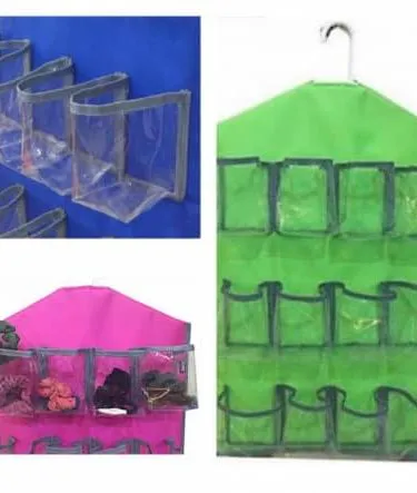 Multi-purpose transparent hanging pockets organizer with multiple compartments hanging on a door.