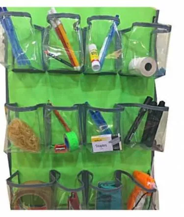 Multi-purpose transparent hanging pockets organizer with multiple compartments hanging on a door.