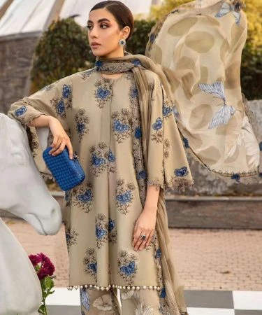 Beautiful woman wearing a vibrant 3-piece lawn summer suit.