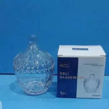 ** Elegant crystal glass sugar pot with an airtight lid, showcasing its clear, high-quality glass and wide mouth, filled with colorful candies or nuts.