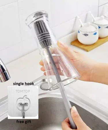 Food-grade silicone bottle cleaning brush with long handle, perfect for baby feeders, sippy cups, glasses, and jars. Features a flexible 360° cleaning head and a hook for easy storage. Ideal for hygienic kitchen cleaning.