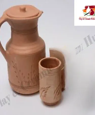 Handmade natural clay jug with a single matching clay glass, perfect for naturally cooling water and adding an earthy touch to your kitchen.