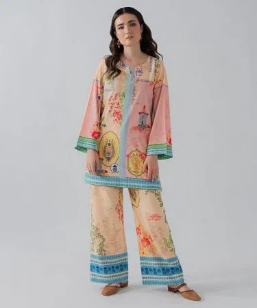 A stylish man modeling a premium two-piece corduroy suit in a rich, earthy brown color, featuring a tailored blazer and matching slim-fit trousers. The texture of the cord fabric is visible, highlighting its sophisticated and comfortable design.