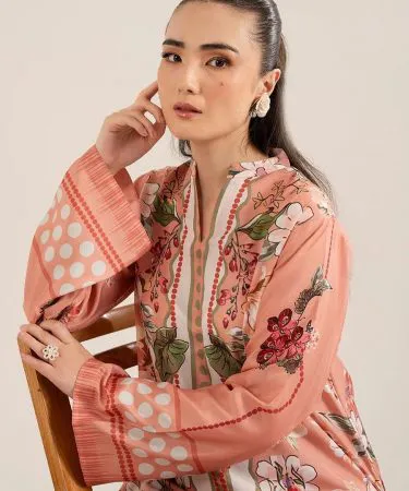 A stylish dark brown 2 Piece Cord Suit, featuring a textured corduroy fabric, worn by a model in a relaxed pose. The suit includes a jacket and trousers, highlighting its comfortable yet fashionable design, perfect for various occasions. Available with Khareedo's Cash on Delivery and open package policy in Pakistan.