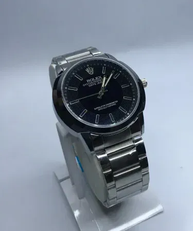 Sleek stainless steel men's watch with a black dial and chronograph features, displayed on a wooden surface, highlighting quality and style for the Pakistani market. Available at Khareedo|Kharedo with Check on Delivery.