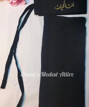 Black Saudi Niqab with custom name embroidery, perfect for an elevated abaya look, available at Khareedo & Kharedo Pakistan.