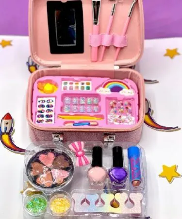 Sparkly pink or purple mermaid-themed 2-in-1 beauty and jewelry make-up set for girls in a zippered suitcase, featuring a vibrant mermaid graphic, with colorful play makeup, nail polish, and hair accessories visible.
