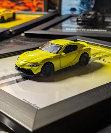 Supra Mk5 3D Diecast Car Frame with opening doors, a premium metal wall decor and car poster for boys and car lovers, displayed on a wall.