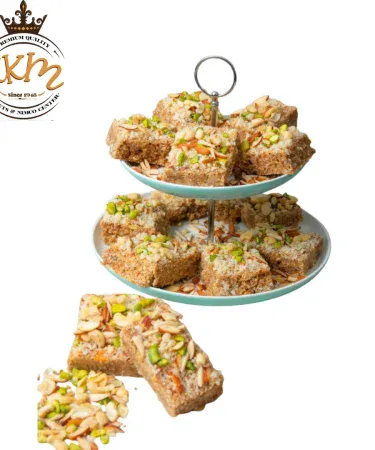 KKM Gur Papri - traditional Pakistani sweet snack made with desi ghee and roasted flour, fresh mithai with a golden brown texture.