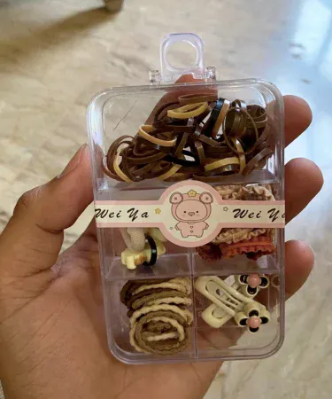 Multi-coloured hair accessories pack for girls, featuring a variety of high-quality hair clips, bands, and ties, perfect for kids. Available at Khareedo and Kharedo.