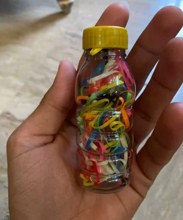 Close-up of a vibrant pack of multicolored rubber bands, perfect for girls' hair accessories. Features elastic hair ties in various bright colors for stylish and secure hairstyles.