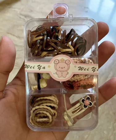 Multi-coloured hair accessories pack for girls, featuring a variety of high-quality hair clips, bands, and ties, perfect for kids. Available at Khareedo and Kharedo.