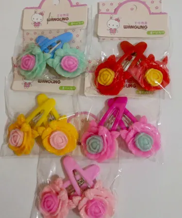 Vibrant multi-coloured rose hair pins for girls, showcasing various delicate floral designs and bright hues.