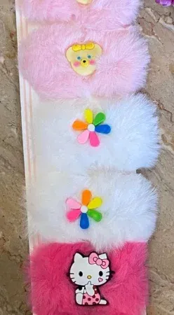 A pair of cute, fluffy pink and purple character fur hair pins for girls, featuring adorable animal or cartoon designs, displayed on a light background.