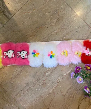 A pair of cute, fluffy pink and purple character fur hair pins for girls, featuring adorable animal or cartoon designs, displayed on a light background.