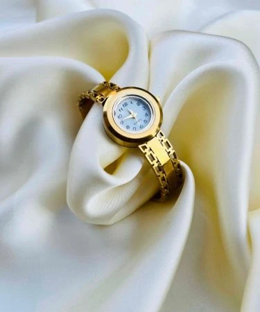 Elegant gold Ladies Bangle Watch for women, featuring a sleek and stylish design, perfect for adding a touch of luxury to any outfit. Available with Khareedo's check on delivery service in Pakistan.