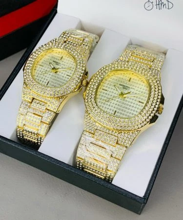 Patek Philippe Golden Full Stone Pair Watch, showing intricate detail of the sparkling case and chain with a butterfly master lock, premium quality luxury timepiece.
