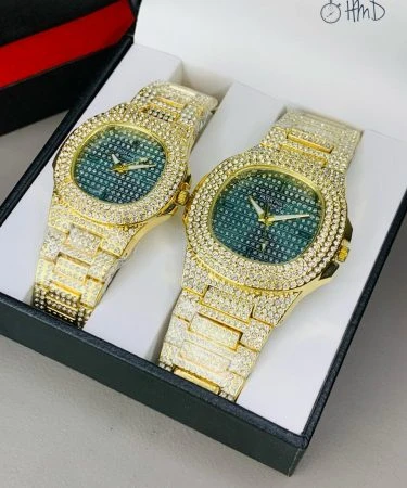Patek Philippe Golden Full Stone Pair Watch, showing intricate detail of the sparkling case and chain with a butterfly master lock, premium quality luxury timepiece.