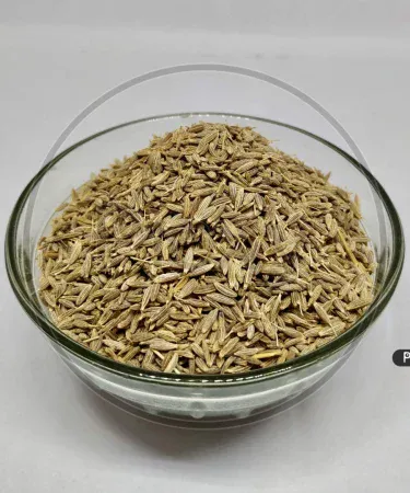 Close-up of golden-brown Premium Zeera (Cumin Seeds) in a wooden bowl, showcasing their pure, natural form and strong aroma, essential for authentic Pakistani cooking. Available for purchase on Khareedo with Check on Delivery and 100% satisfaction.