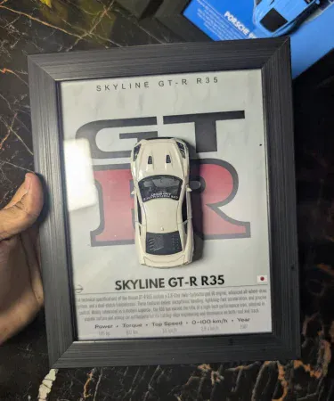 Nissan GTR R35 3D Diecast Metal Car Frame wall art for boys room, featuring a 1:43 scale model with opening doors in a premium 10.5x8.5 inch frame.