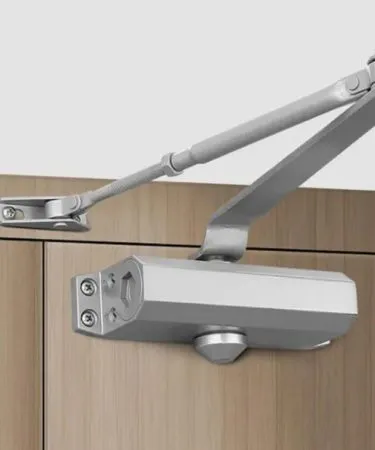 Small residential automatic hydraulic door closer in aluminum finish, UL listed for interior and exterior use, showing parallel and regular arm types, ANSI Grade 2 compliant.