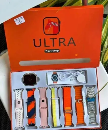 Image of a 7 in 1 Ultra Smart Watch with 7 interchangeable belts in Orange, Silver, and Black, showing the smartwatch with a wireless charger.