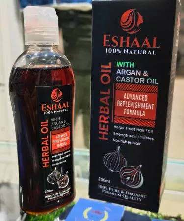 Eshaal Herbal Hair Oil bottle with natural ingredients and healthy hair illustration**