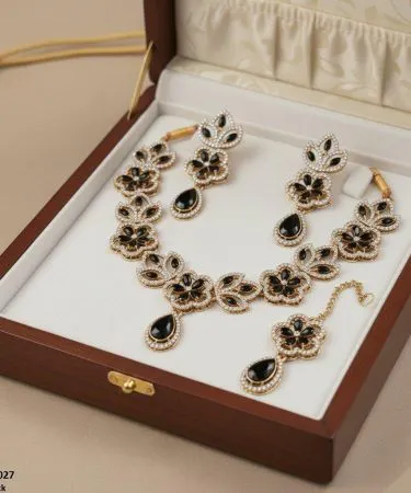 Golden plated Tear Flower Necklace Set for women with synthetic stones, including matching earrings and bindi, ideal for formal and party wear.
