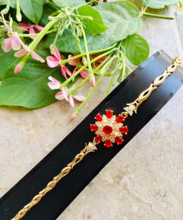 Elegant Golden Maroon Zircon Bracelet with beautiful gift box, showcasing the maroon stone and golden finish on a luxurious background.