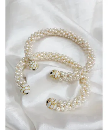 Two elegant free size pearl bangles, a two-piece set featuring lustrous pearls, displayed on a minimalist background. Perfect for Pakistani traditional wear or modern outfits. Buy online with Khareedo and Kharedo with check on delivery.