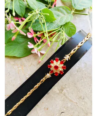 Elegant Golden Maroon Zircon Bracelet with beautiful gift box, showcasing the maroon stone and golden finish on a luxurious background.