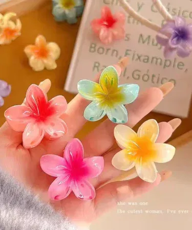 Close-up of a small white Hawaiian Plumeria flower shaped hair claw, featuring a strong non-slip grip suitable for women and girls with thick or thin hair, ideal for summer beach headwear.