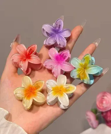 Close-up of a small white Hawaiian Plumeria flower shaped hair claw, featuring a strong non-slip grip suitable for women and girls with thick or thin hair, ideal for summer beach headwear.