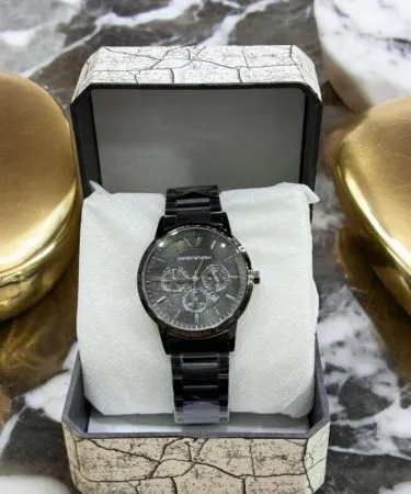 Men's black chronograph watch with rose gold dial and steel chain strap**