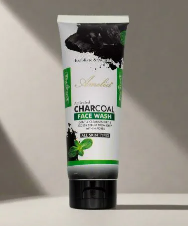Amelia Activated Charcoal Face Wash bottle with charcoal texture background, suitable for oily and acne‑prone skin, displayed on a clean bathroom shelf.