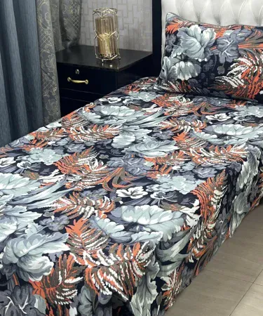 Single cotton bedsheet with matching pillow cover for a single bed, neatly folded on a wooden surface, showcasing the soft texture and vibrant color. , imagecaption=Premium Single Bedsheet Set with Pillow Cover – Perfect for a cozy single bed, available on Khareedo | Kharedo. ,