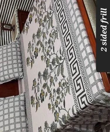 King size double frill cotton bedsheet with two matching pillow covers elegantly displayed on a neatly made bed, soft lighting highlighting the frill details.