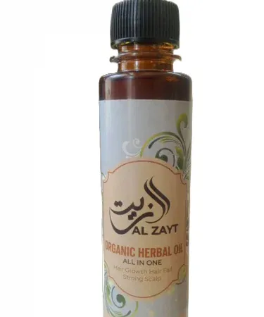 Bottle of organic herbal hair oil featuring coconut, argan, rosemary and amla oils