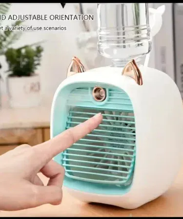Cooling spray fan desktop USB mini portable air conditioner on a desk, imagecaption=Compact USB cooling spray fan – perfect for office, dormitory, and home use,