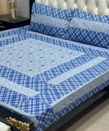 Beautiful embroidered patch work bedsheet with two matching pillow covers on a neatly made bed, showcasing vibrant colors and intricate stitching.