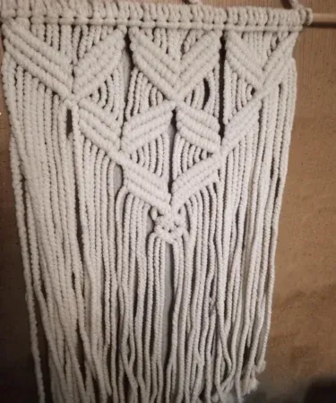 Handmade 12x18 inch macrame wall hanging with natural off‑white cotton rope, perfect boho décor for living room or bedroom.