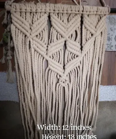 Handmade 12x18 inch macrame wall hanging with natural off‑white cotton rope, perfect boho décor for living room or bedroom.