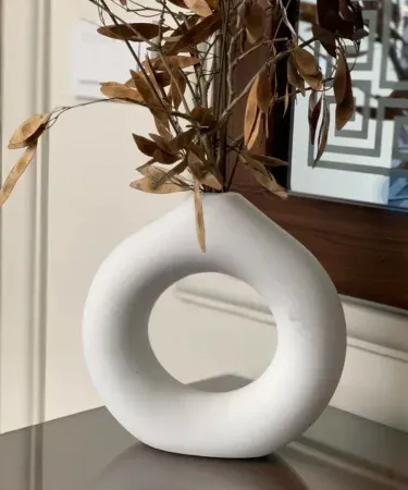 Handmade doughnut shaped flower vase 8x8 inches, modern home décor piece displayed with artificial flowers, high‑quality painted finish, suitable for table and shelf decoration,