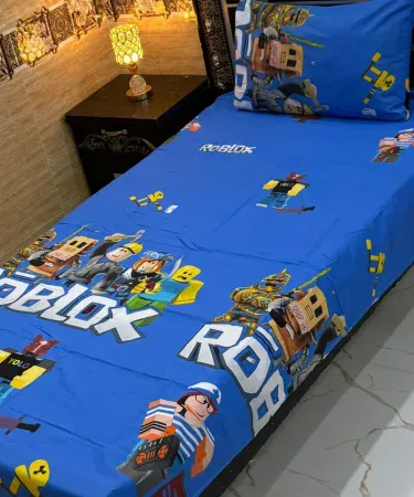 Pure Comfort 100% cotton single kids cartoon printed bed sheet – soft, colorful, perfect for children’s rooms, imagecaption=Kids enjoying a cozy night on the Pure Comfort 100% cotton cartoon printed single bed sheet.,