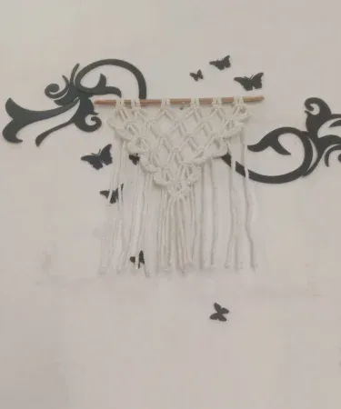 small handcrafted macrame wall hanging design for home décor , imagecaption=Elegant small macrame wall hanging – perfect for any wall ,