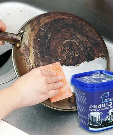 Rust Cream Powerful Stainless Steel Cookware Cleaning Paste tube on a kitchen countertop, imagecaption=Rust Cream – Strong stainless steel cleaning paste for removing rust, stains and scale from pots, pans and sinks.
