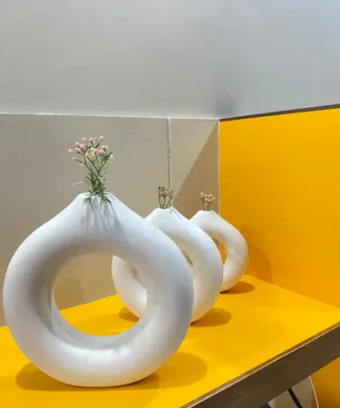 hand‑made set of three donut shaped vases in mate colour, painted plaster of Paris décor piece