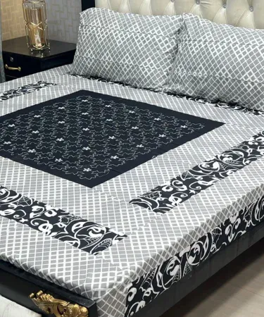 Beautiful embroidered patch work bedsheet with two matching pillow covers on a neatly made bed, showcasing vibrant colors and intricate stitching.