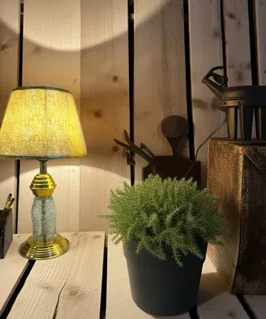 golden table lamp with fancy shadow casting elegant light on a modern living room table, imagecaption=Elegant Golden Table Lamp 1 pcs with Fancy Shadow – Perfect for Home Décor.