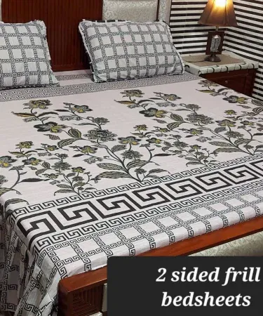King size double frill cotton bedsheet with two matching pillow covers elegantly displayed on a neatly made bed, soft lighting highlighting the frill details.